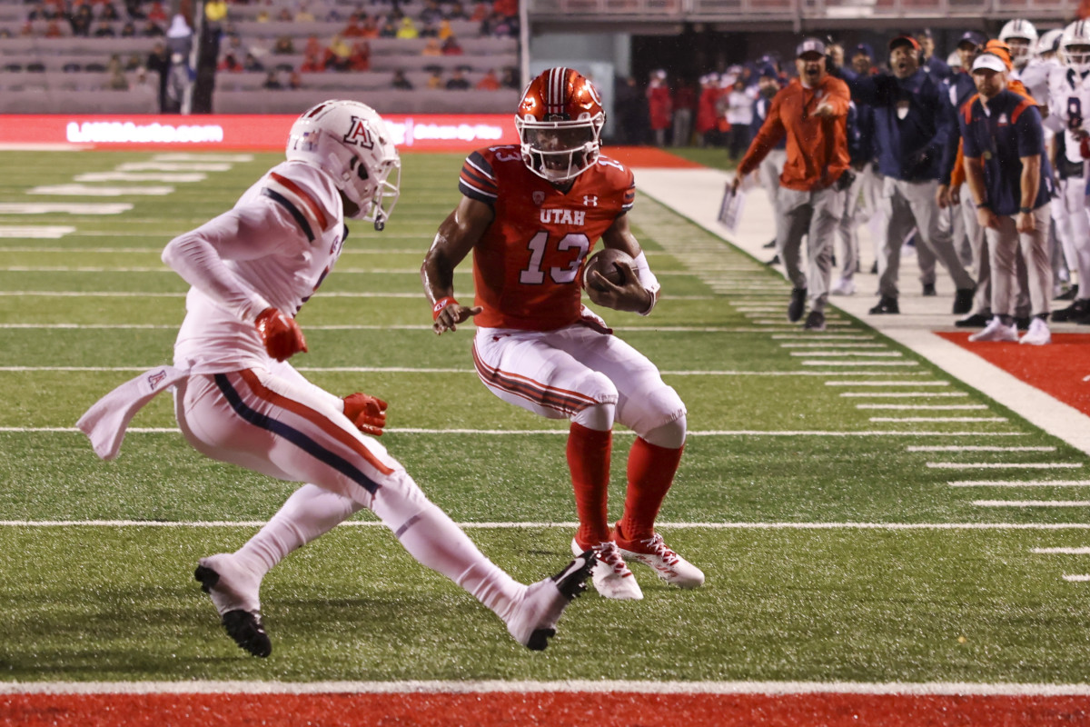 Utah Utes quarterback Nate Johnson (13) runs the ball for a touchdown against Arizona Wildcats cornerback Ephesians Prysock (7) in the second quarter at Rice-Eccles Stadium.